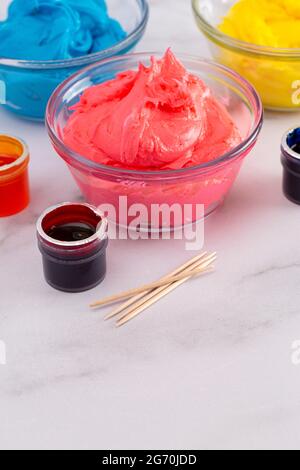 Opened Pot of Gel Food Coloring on a Marble Counter Top Stock Photo