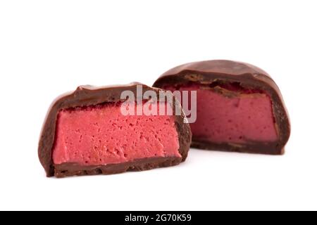 A Chocolate Red Raspberry Truffle Cut Open and Isolated on a White Background Stock Photo