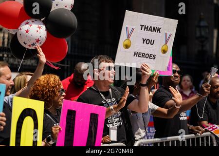 New York, USA. 7th Jul, 2021. Spectators cheer during a Hometown Heroes ticker tape parade through the Canyon of Heroes in New York, USA. The parade honored the healthcare and essential workers who helped the city through the COVID-19 pandemic. Credit: Chase Sutton/Alamy Live News Stock Photo