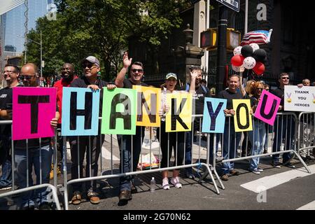 New York, USA. 7th Jul, 2021. Spectators cheer during a Hometown Heroes ticker tape parade through the Canyon of Heroes in New York, USA. The parade honored the healthcare and essential workers who helped the city through the COVID-19 pandemic. Credit: Chase Sutton/Alamy Live News Stock Photo