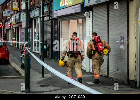 Manchester, UK. 09th July, 2021. Firefighters walk to the scene of the house fire in Manchester.Greater Manchester Fire Service block off Norman Street, Failsworth after a house fire in a flat on Manchester Road. Residents say the house fire was caused by a man who wanted to commit suicide however conflicting reports also came me that the man was cooking. Two fire trucks and a fire commander responded to the scene. (Photo by Ryan Jenkinson/SOPA Images/Sipa USA) Credit: Sipa USA/Alamy Live News Stock Photo