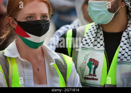 London, UK. 09th July, 2021. A protester seen wearing a Palestinian flag face mask and another a free Palestine scarf during the protest.Students and other protesters go on a tour of London Universities to demand a boycott for all Israeli academic and cultural institutions in solidarity with the struggle to end Israel's occupation, colonisation and system of apartheid in Israel. (Photo by Martin Pope/ SOPA Images/Sipa USA) Credit: Sipa USA/Alamy Live News Stock Photo