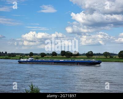 Binnenvaart, Translation Inlandshipping on the river Rhein Krefeld Netherlands July 2021, during sunset hours, Gas tanker vessel oil and gas transport Germany. Stock Photo