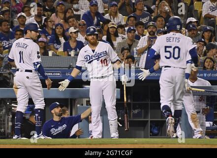 Los Angeles, USA. 10th July, 2021. Los Angeles Dodgers Justin Turner (10) celebrates with teammates AJ Pollock (11) and Mookie Betts (50) after Pollock scored from third on Betts' grounder to third to pull within 3-2 in the bottom of the seventh inning at Dodger Stadium in Los Angeles on Friday, July 9, 2021. The Diamondbacks defeated the Dodgers 5-2. Photo by Jim Ruymen/UPI Credit: UPI/Alamy Live News Stock Photo