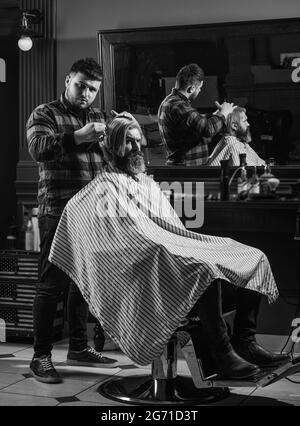 Cut hair. Barber hairstyle barbershop. Professional cosmetics. Hipster getting haircut. Healthy hair. Annoy barber could turn out poorly for your ear Stock Photo
