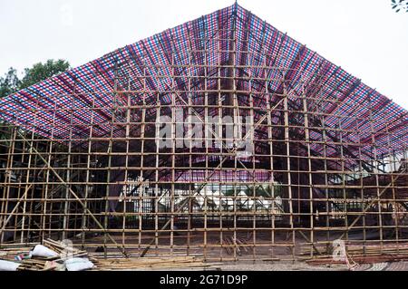 Asian people macanese workers working builder new building with bamboo scaffolding in construction site in Senado Senate Square at Macao Special Admin Stock Photo