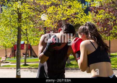 Young fit couple practicing boxing in a park Stock Photo