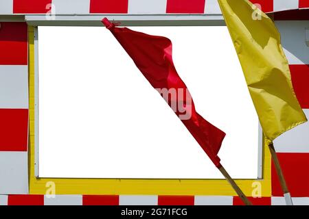 Texture of multi-colored festive red, yellow flags made of fabric. Holiday celebration satin flags of different colors in the wind Stock Photo