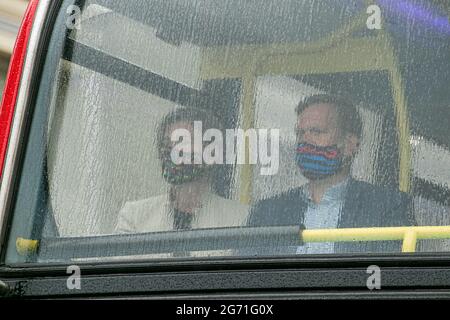 London, UK. 10th July, 2021. Tennis fans sitting behind the window of a  shuttle bus covered in raindrops  to the All England Lawn Tennis Club for  Ladies's singles final day at Wimbledon. Credit: amer ghazzal/Alamy Live News Stock Photo