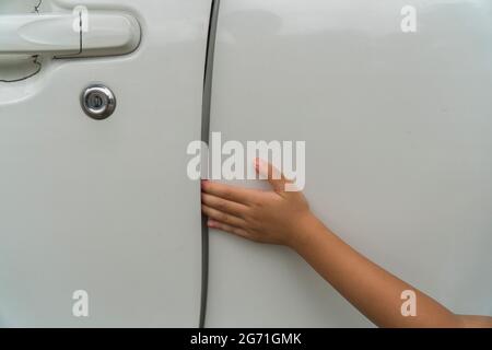 kid hand or finger pinched by the car door close up portrait of