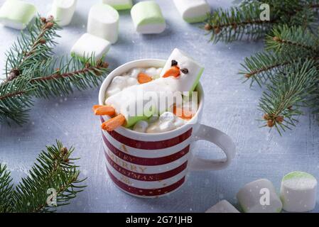 Christmas card with cup of hot chocolate with melted marshmallow snowman Stock Photo