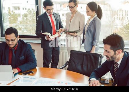 Very international consultants working on a project together Stock Photo