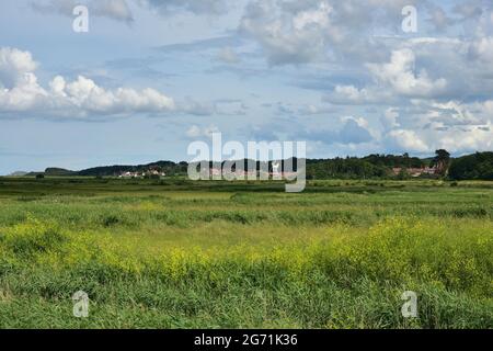 Cley next to the sea,  windmill, seen across the marshes from Blakeney, Norfolk Stock Photo