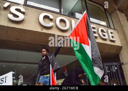 London, UK. 9th July 2021. Demonstrators outside King's College London during the Student Protest For Palestine. Demonstrators marched to various universities in central London demanding they divest from 'all companies complicit in Israeli violations of international law' and that they sever 'all links with complicit Israeli institutions'. Stock Photo