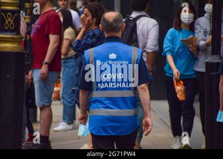 London, United Kingdom. 9th July 2021. COVID Marshals on patrol in Shaftesbury Avenue. Stock Photo