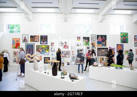 EDITORIAL USE ONLY Young artists and visitors view works at the opening ...