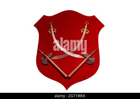 Swords and axes on a red velvet shield isolated on white background Stock Photo