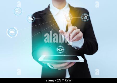Woman In Uniform Standing Carrying Phone Pointing On Virtual Interface Display Icons. Lady In Suit Holding Mobile Device Points Towards Innovative Stock Photo