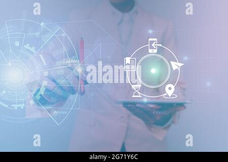 Woman In Uniform Standing Holding Tablet Showing Futuristic Virtual Interface. Lady In Suit Using Pencil Mobile Device Interacting With Holographic Stock Photo