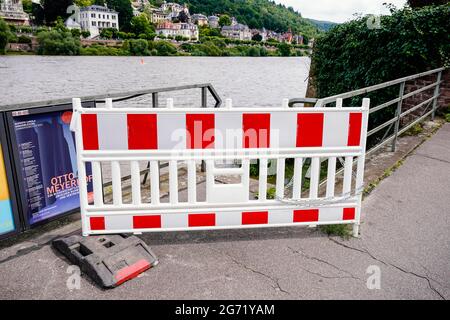 Heidelberg, Germany. 10th July, 2021. A barrier stands in front of an access to the banks of the Neckar. The water level is expected to rise above the navigation limit on Saturday. Credit: Uwe Anspach/dpa/Alamy Live News Stock Photo