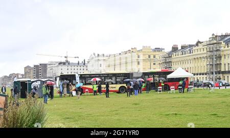 Brighton, UK. 10th July 2021. - A  Brighton & Hove bus being used as a mobile NHS COVID-19 Vaccination Centre on Hove Lawns today . There has been a steep rise in positive COVID-19 cases in the city over the last 2 weeks : Credit Simon Dack / Alamy Live News Stock Photo