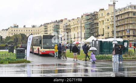 Brighton, UK. 10th July 2021. - A  Brighton & Hove bus being used as a mobile NHS COVID-19 Vaccination Centre on Hove Lawns today . There has been a steep rise in positive COVID-19 cases in the city over the last 2 weeks : Credit Simon Dack / Alamy Live News Stock Photo