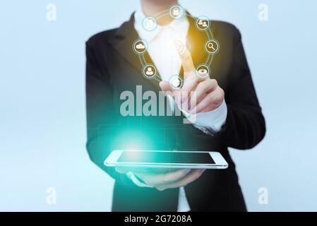 Woman In Uniform Standing Carrying Phone Pointing On Virtual Interface Display Icons. Lady In Suit Holding Mobile Device Points Towards Innovative Stock Photo