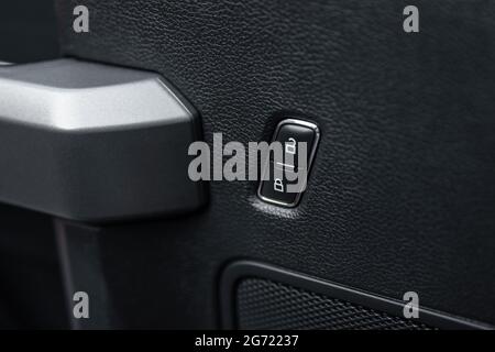 Car door lock unlock button close up. Electric central locking button in modern car. Selective focus. Stock Photo