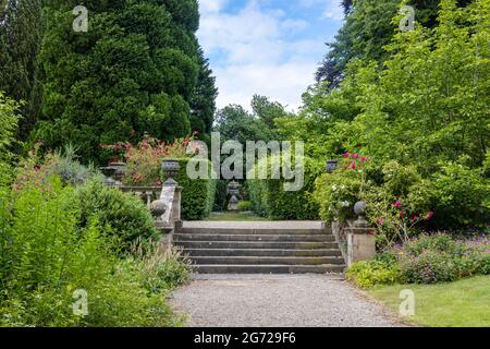 Old stone terraced garden steps and balustrade with decorative planters in a park. Stock Photo