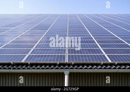 roof-mounted solar collectors on large roof Stock Photo