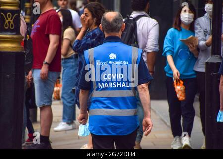 London, UK. 09th July, 2021. A COVID-19 Marshal seen on patrol in Shaftesbury Avenue, central London, as coronavirus infections continue to rise again in England. Credit: SOPA Images Limited/Alamy Live News Stock Photo