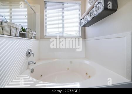 Round jacuzzi in a bathroom with windows Stock Photo