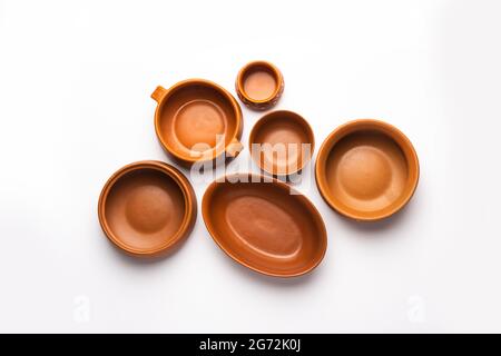 Collection of empty colorful ceramic bowls. Group of utensils captured from above, top view, flat lay against white background Stock Photo