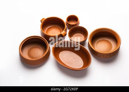 Collection of empty colorful ceramic bowls. Group of utensils captured from above, top view, flat lay against white background Stock Photo