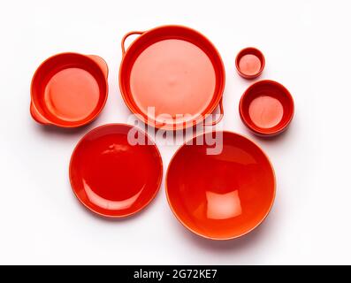 Collection of empty colorful ceramic bowls. Group of utensils captured from above, top view, flat lay against white background Stock Photo