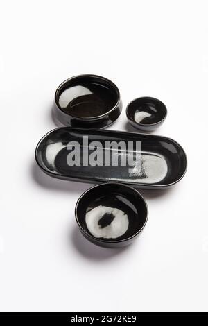 Collection of empty colorful ceramic bowls. Group of utensils captured from above, top view, flat lay against white background Stock Photo