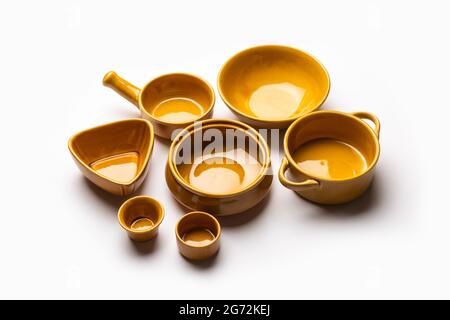 Collection of empty colorful ceramic bowls. Group of utensils captured from above, top view, flat lay against white background Stock Photo