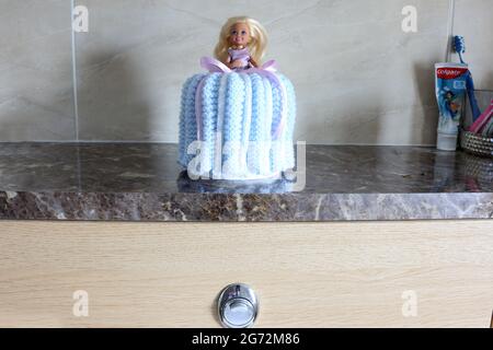 Toilet Doll, a Barbie doll with crochet dress over a toliet roll Stock Photo