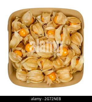 Fresh goldenberries in their husk, in a paper snacktray. Also ground cherry, Cape gooseberry, uchuva or poha, fruits of Physalis peruviana. Stock Photo