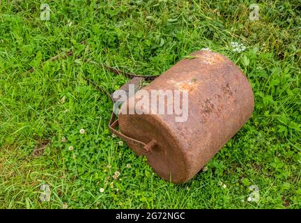 Rusty old grass lawn, bowling green roller. Forgotten. Stock Photo