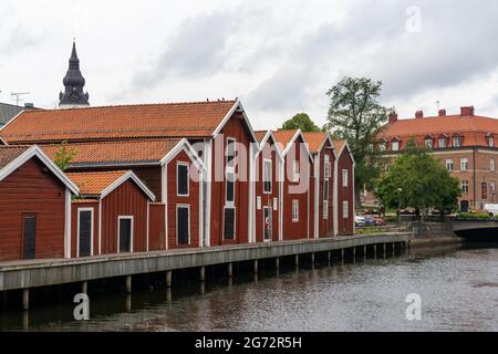 Hudiksvall, Sweden - 7 July, 2021: colorful wooden buildings line the canal in downtown Hudiskvall Stock Photo