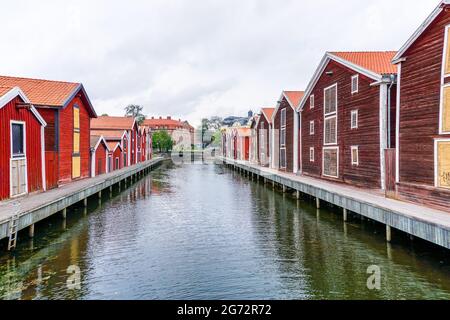 Hudiksvall, Sweden - 7 July, 2021: colorful wooden buildings line the canal in downtown Hudiskvall Stock Photo