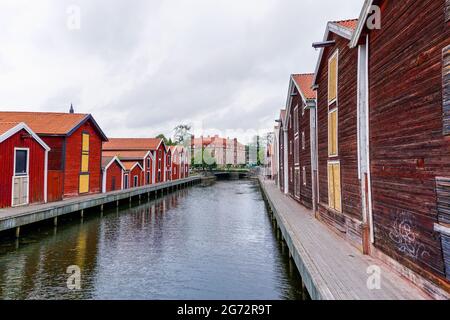 Hudiksvall, Sweden - 7 July, 2021: colorful wooden buildings line the canal in downtown Hudiskvall Stock Photo