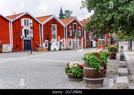 Hudiksvall, Sweden - 7 July, 2021: colorful wooden buildings line the canal in downtown Hudiskvall Stock Photo