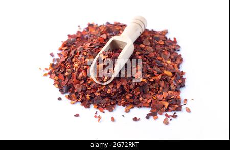 Pile of crushed red chilli pepper, dried cayenne pepper flakes isolated on white background Stock Photo