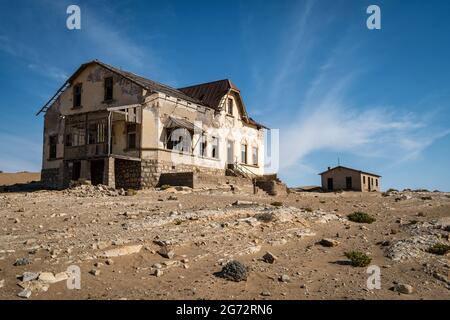 Abandoned buildings in the Kolmanskop ghost town near Luderitz, Namib Desert, Namibia. Stock Photo