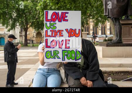 London, UK. 10th July, 2021. Protesters with a placard saying 'Love us like you love our food' take part during a Stop Asian Hate protest at Parliament Square in London.Anti-Asian violence and abuse has escalated since the COVID-19 pandemic first case was reported in the city of Wuhan, in Hubei province of China. (Photo by Dave Rushen/SOPA Images/Sipa USA) Credit: Sipa USA/Alamy Live News Stock Photo