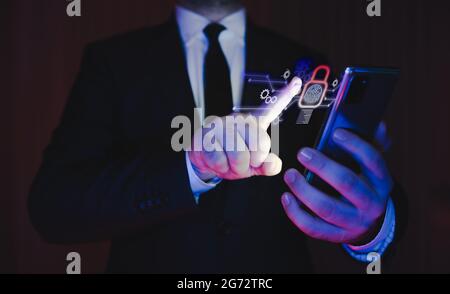 businessman in suit holding smartphone using fingerprint security system. biometric security system with mobile technology. Stock Photo