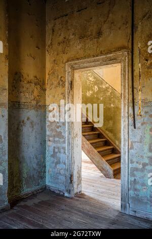 Abandoned building in the old mining town of Kolmanskop near Luderitz, Namib Desert, Namibia. Stock Photo