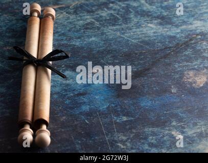 Closed Antique Scroll on a Rustic Blue Wooden Table Stock Photo